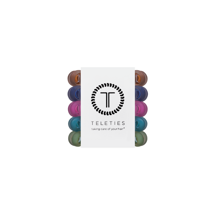 Pack of Sweater Swatches Tiny Hair Ties in assorted colors, mini spiral bands arranged vertically with a central white label featuring the brand logo and “taking care of your hair” slogan. Available in mini size.