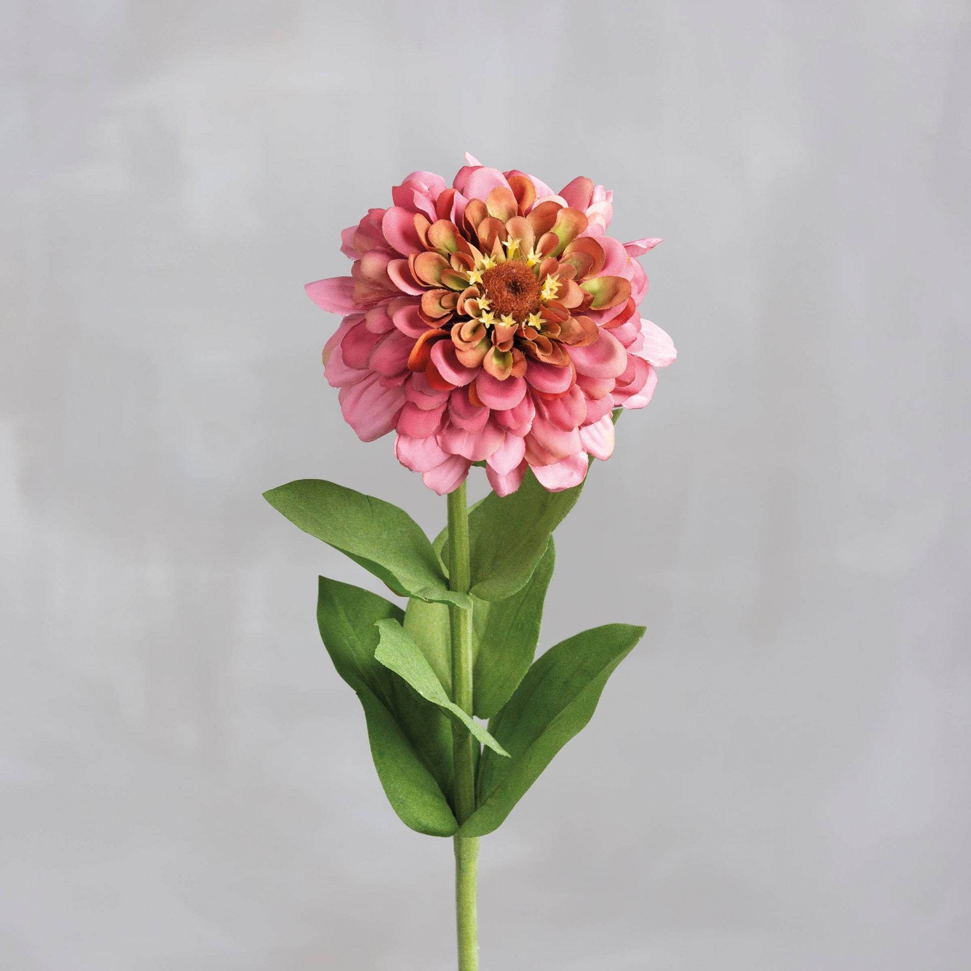 Pink Zinnia Floral Pick with layered petals, green leaves, and long stem. Available in 12-inch and 18-inch sizes.