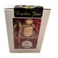 Car Diffusers": Packaged gift item with a wooden piece resembling honey dippers and a bottle labeled "Fall Leaves." Refreshing scent ideal for car use. Presented with pink shredded paper for added charm. Available size: one standard set.