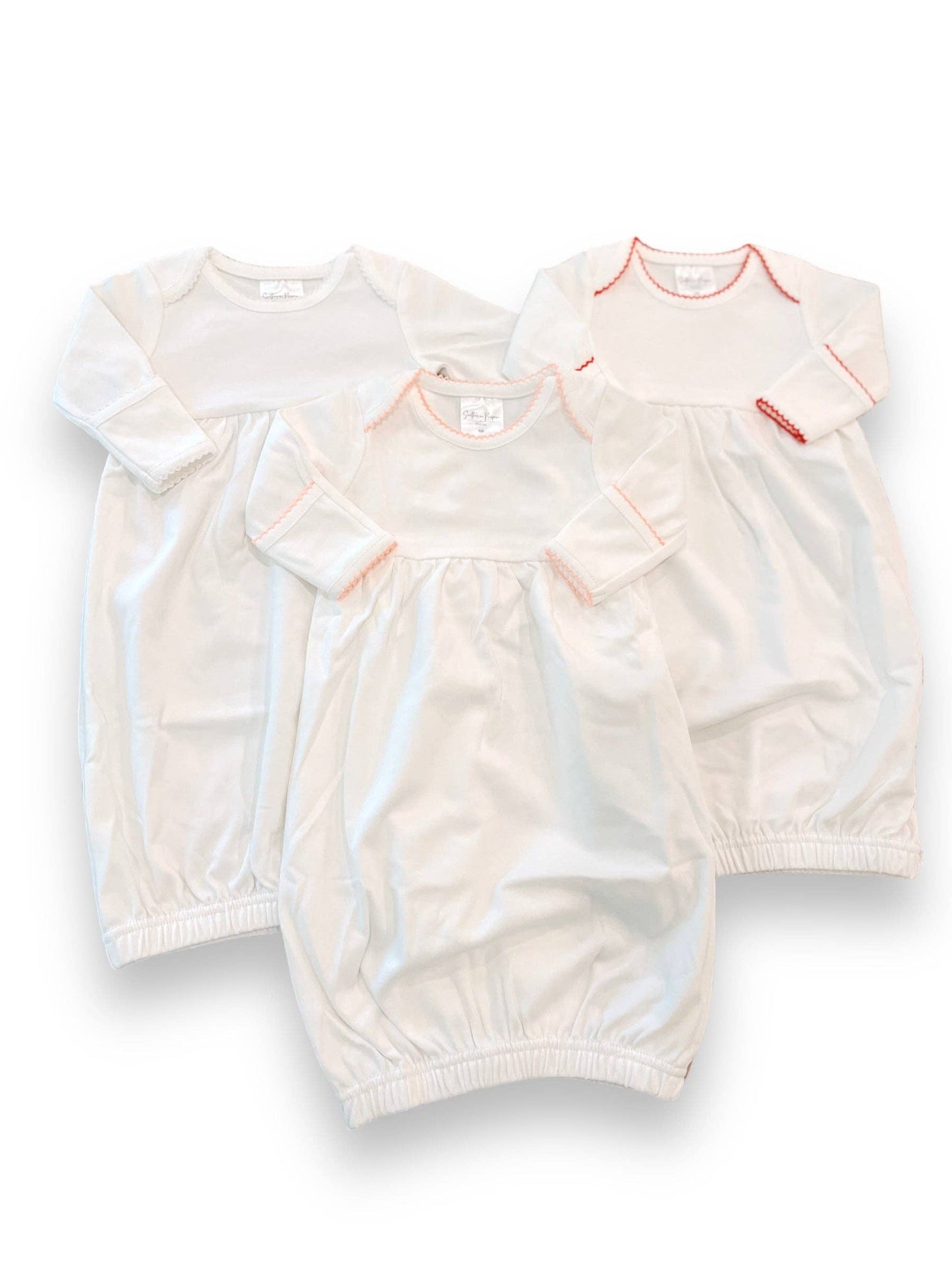 Three Picot Trimmed Baby Sleeping Gowns made of 100% cotton on a white background, one with red stitching and decorative picot trim on the collar and sleeves.