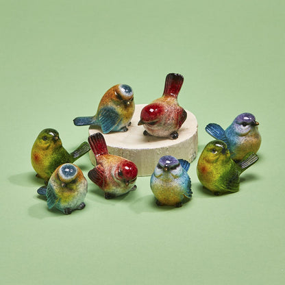 Hand-painted resin bird decor piece on a white wooden pedestal. Available sizes not specified.