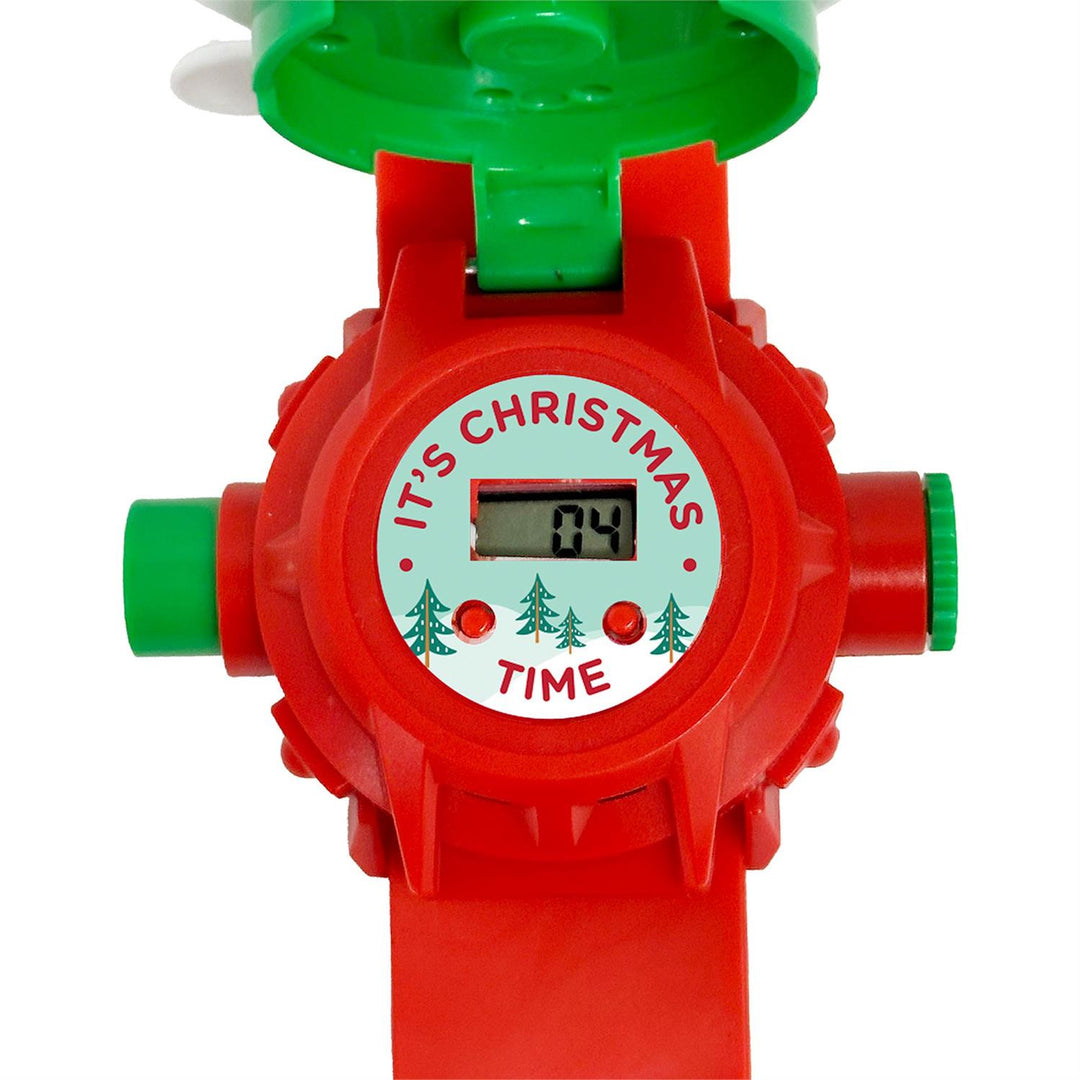 Red Santa Projector Watch with a hinged green cover, featuring a circular face that reads “IT’S CHRISTMAS TIME” and displays the digits “04” beneath decorative pine tree icons.