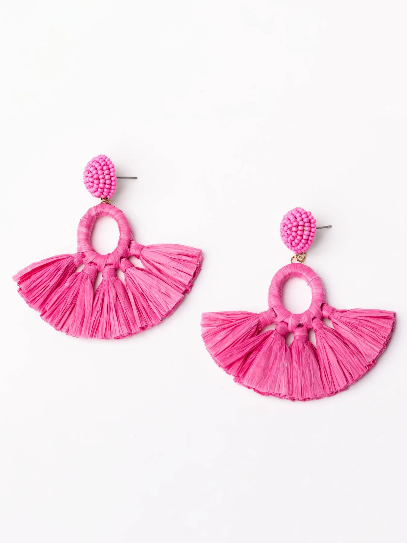 The Alexa Earrings are a unique pair highlighted by a circular beaded top and a fan-shaped tassel bottom in vibrant pink. Compact yet glamorous, these earrings provide bold punctuation to any attire. They are available in one standard size, perfect for an easy fit for everyone.