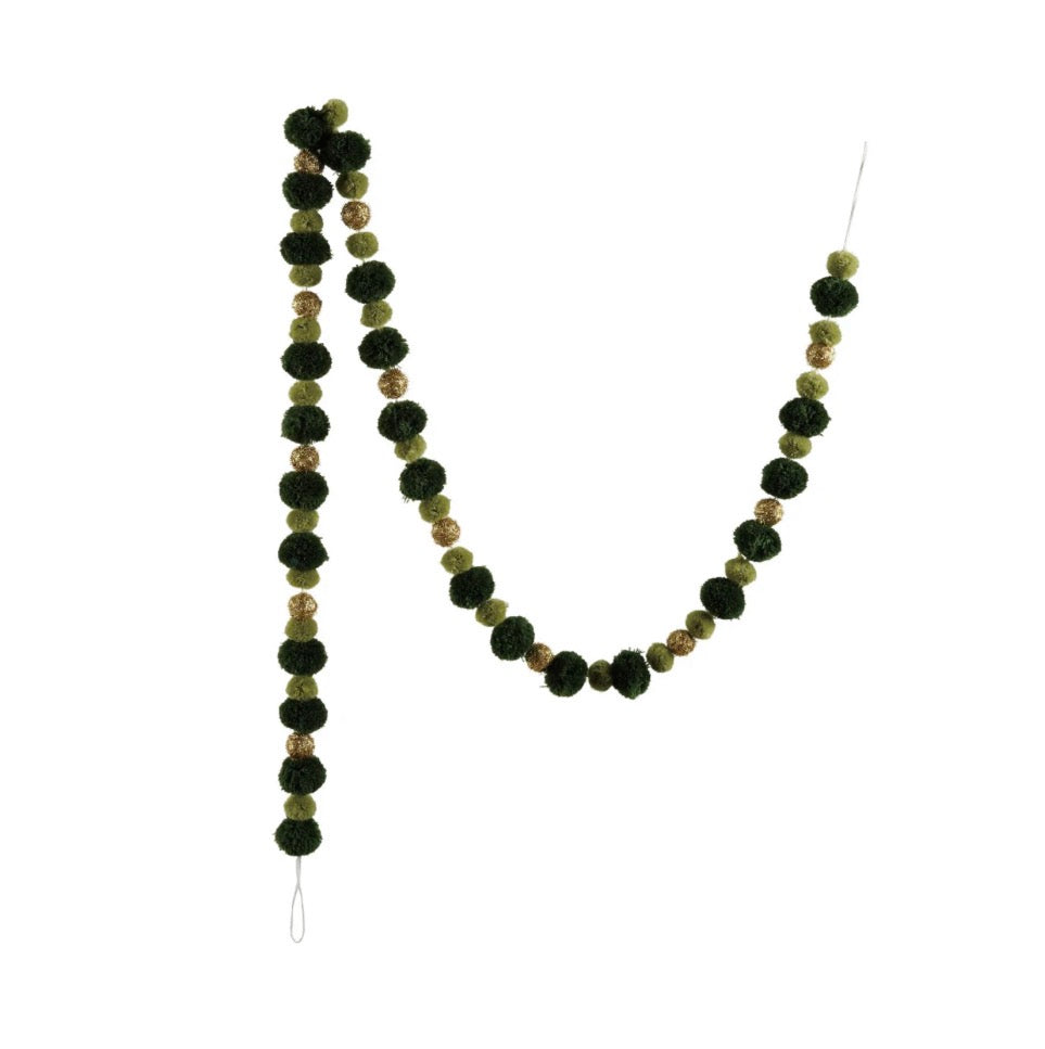 Green and gold pom-pom garland with alternating dark green, light green, and glittery gold pom-poms on a thin cord.