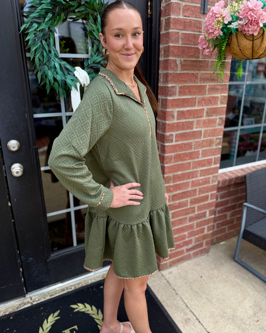 Adriana Olive Dress featuring subtle leopard-print trim. Available in sizes XS–XL.