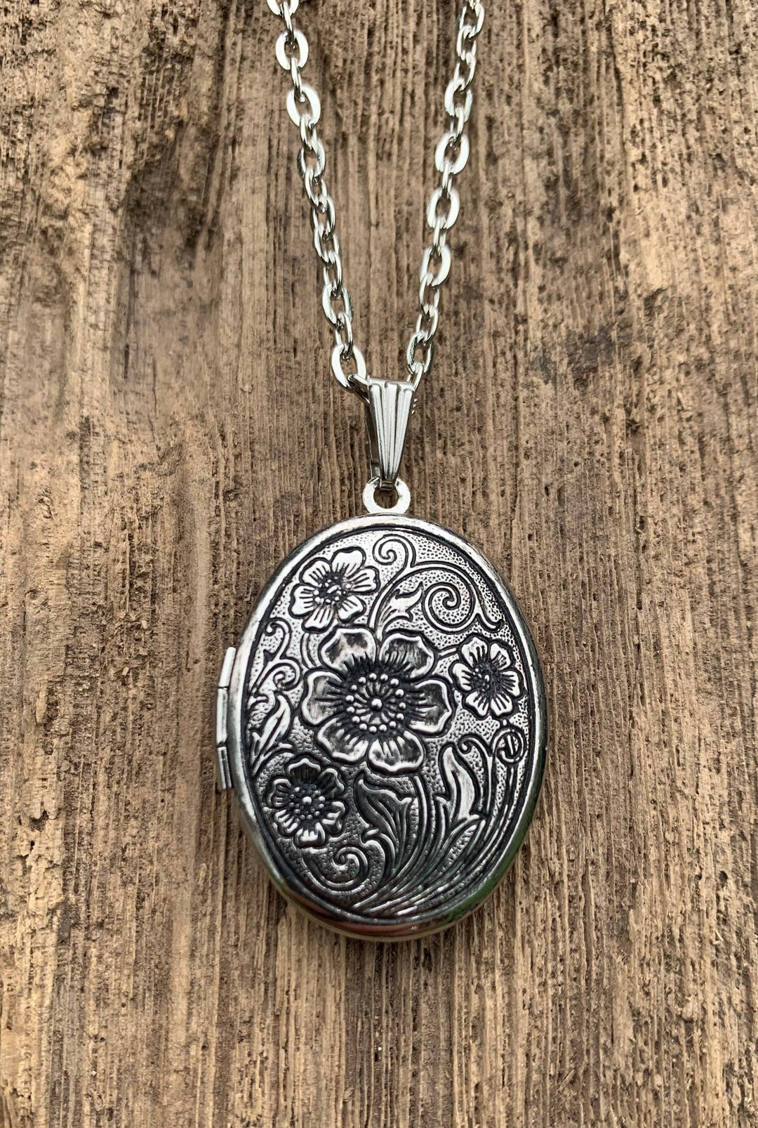 Antiqued silver locket with engraved floral design, matching chain, gardenia solid perfume inside. Available in 1" and 1.5" sizes.