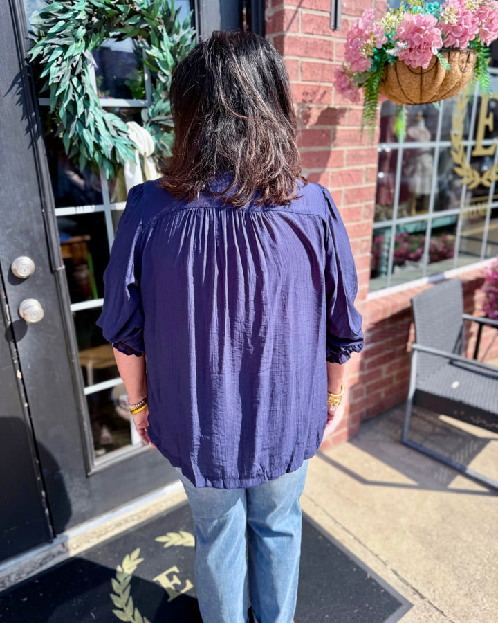 Navy Smocked Yoke Button Front Blouse, available in sizes XS–XL.