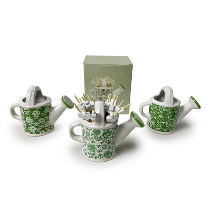 Set of three mini green floral watering cans with flower picks. Each can approx. 2" tall. Matching display box included.