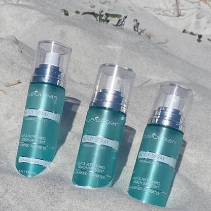 Three teal True Ocean Body Spray bottles, 3.4 oz each, with clear caps and silver accents. "Coastal Sunkissed Fragrance Mist.