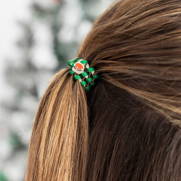 Small green braided spiral coil hair tie with a Santa Claus charm.