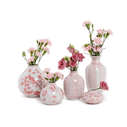 Five hand-painted white ceramic vases with unique pink floral and abstract patterns, arranged in a row. Each vase holds pink carnations and rose-like flowers. Sizes: Small, Medium, Large.