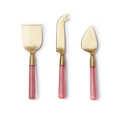 The Pink Blush Set of 3 Cheese Knives features pink handles and gold-colored blades. Includes a flat spreader, fork-tipped knife, and pointed blade. Made from high-quality acrylic and stainless steel with smooth glossy handles and matte blades. Comes in a gift box. Sizes: not applicable (one size).