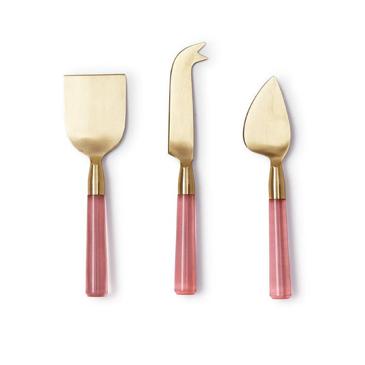 The Pink Blush Set of 3 Cheese Knives features pink handles and gold-colored blades. Includes a flat spreader, fork-tipped knife, and pointed blade. Made from high-quality acrylic and stainless steel with smooth glossy handles and matte blades. Comes in a gift box. Sizes: not applicable (one size).