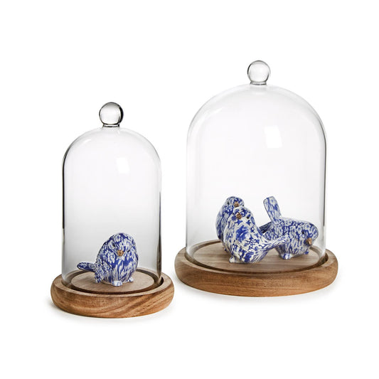 Set of two glass cloches with ball handles and wood bases, available in small and large sizes.