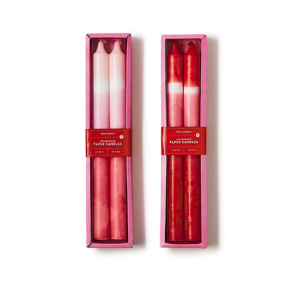 Color Block Taper Candles in pink boxes with red labels; one pink gradient, one red marbled. Available in 10" and 12" sizes.