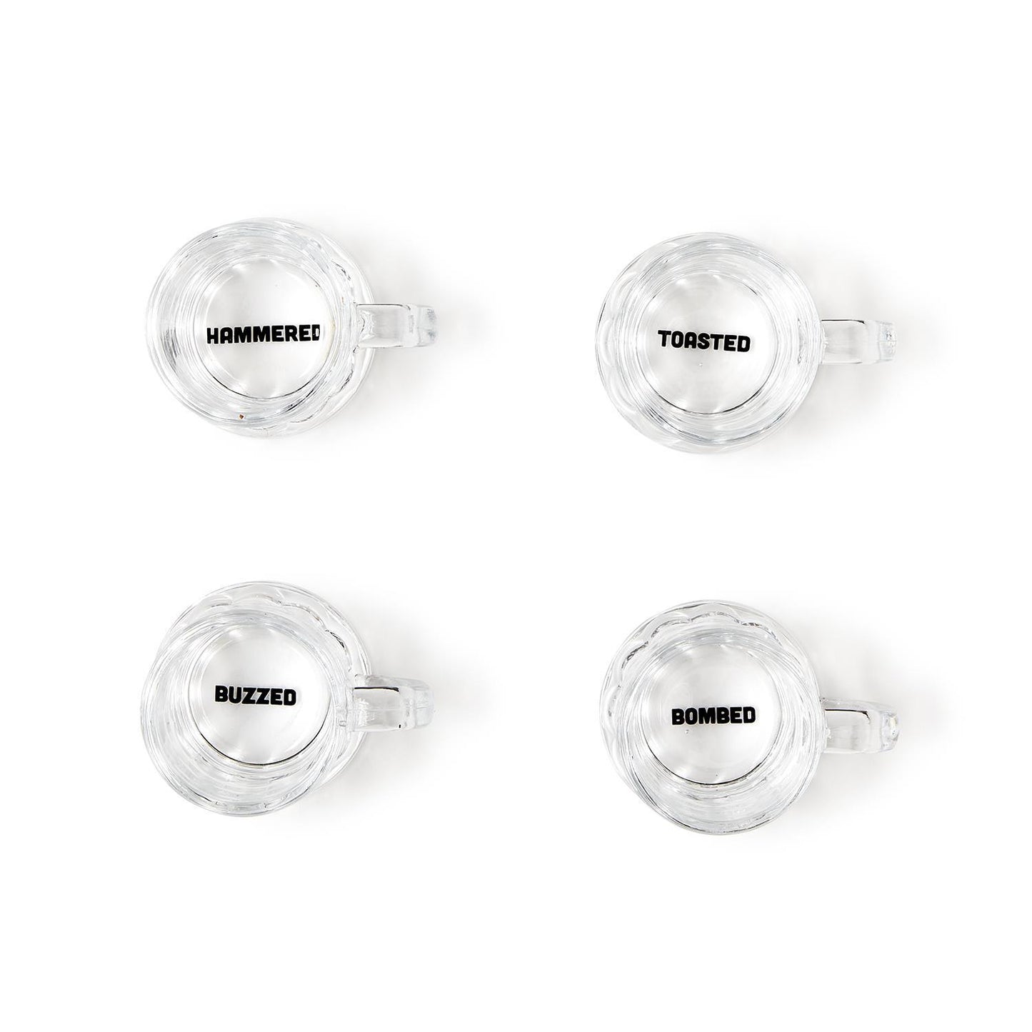 Set of four clear shot glasses labeled "HAMMERED," "TOASTED," "BUZZED," and "BOMBED." Each holds 2 oz. Gift box included.