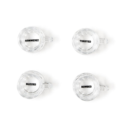 Set of four clear shot glasses labeled "HAMMERED," "TOASTED," "BUZZED," and "BOMBED." Each holds 2 oz. Gift box included.