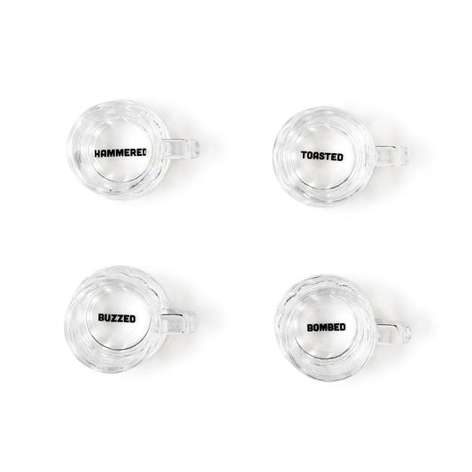 Set of four clear shot glasses labeled "HAMMERED," "TOASTED," "BUZZED," and "BOMBED." Each holds 2 oz. Gift box included.