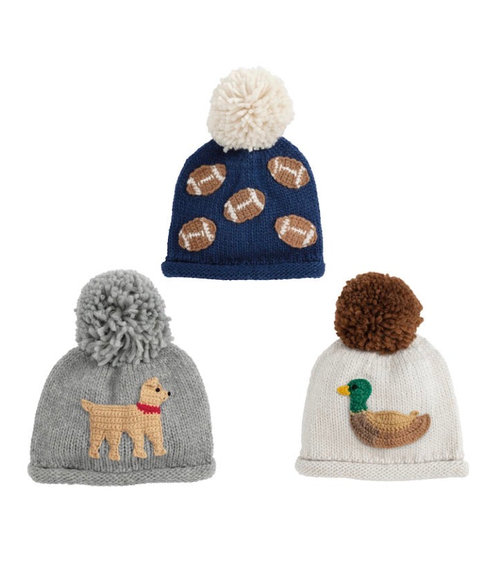 Chunky knit hats in navy with football appliqué, gray with yellow dog, and white with green-headed duck. Available in sizes S, M, L.