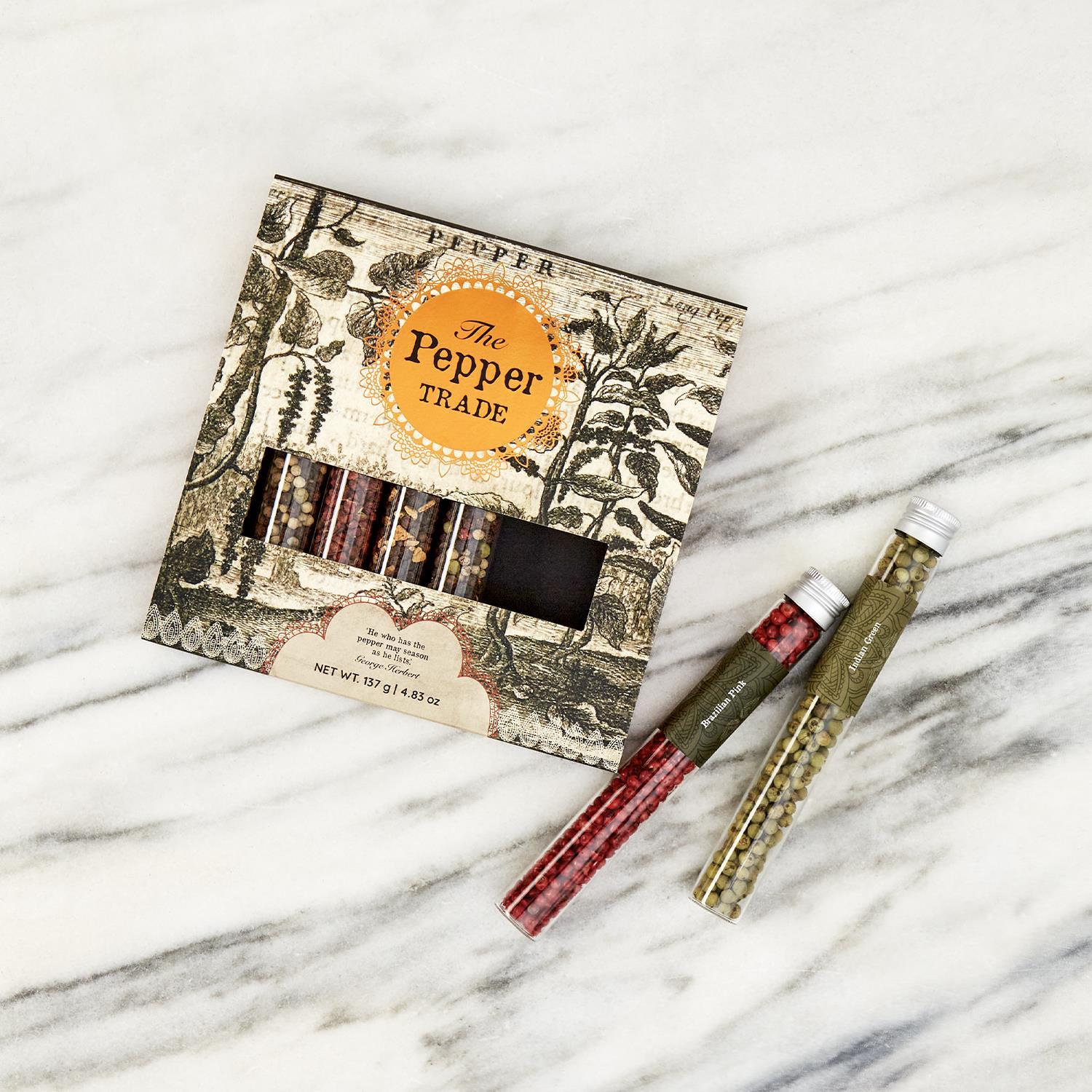 The Pepper Trade 8 Tube Gift Set features a collection of gourmet peppercorns, elegantly packaged in tubes with vintage botanical illustrations. Available as an 8-tube set.