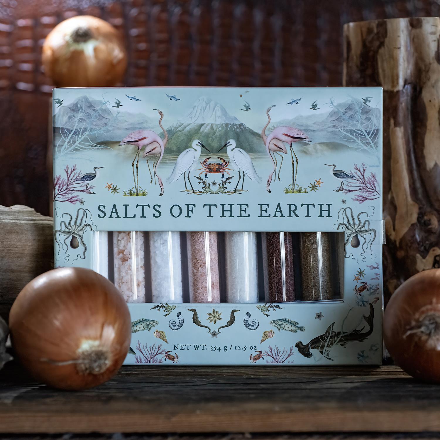 The "Salts of the Earth 8 Tube Gift Set" features unique salts in clear tubes, adorned with illustrations and natural motifs. Perfect for enhancing flavors and inspiring culinary creations.