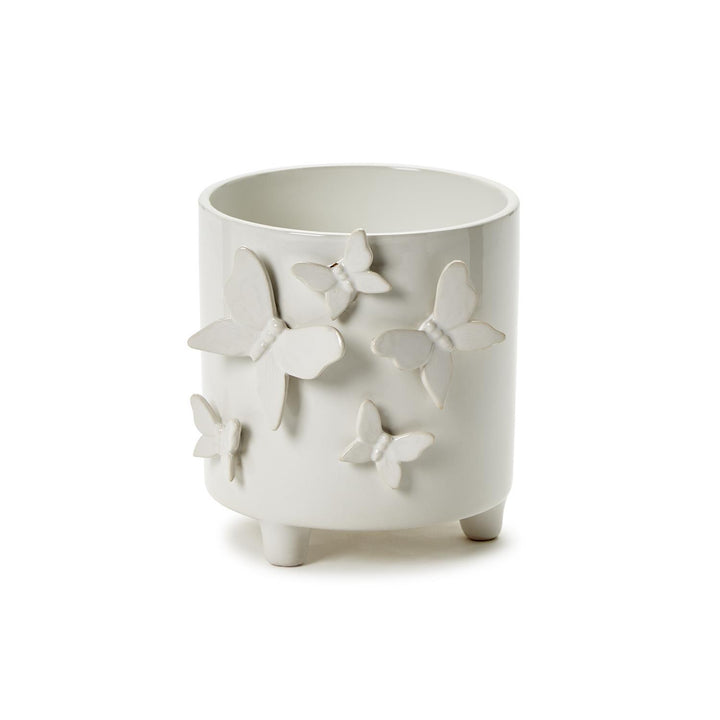 White ceramic cachepot on three short legs with raised butterfly accents. Available in multiple sizes.