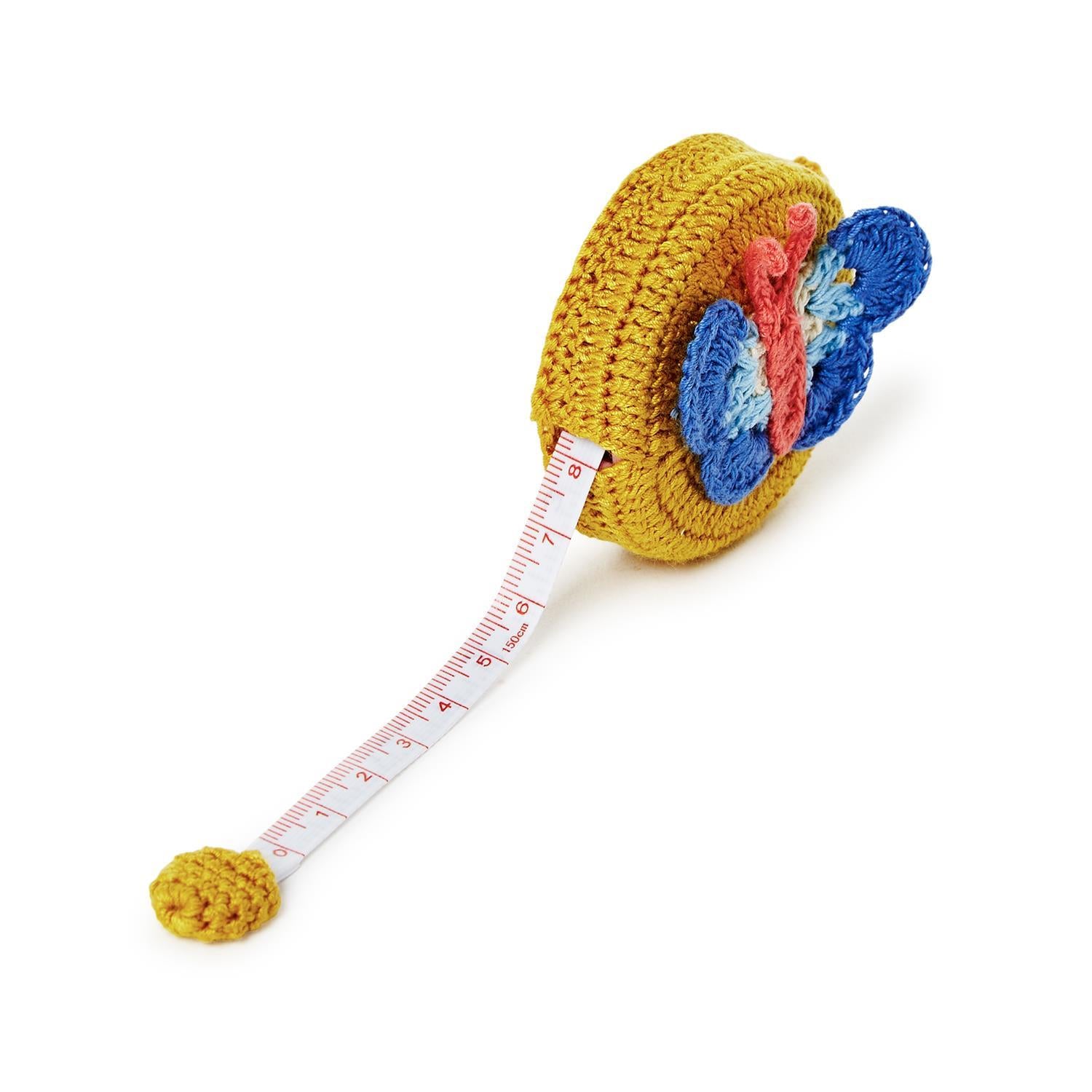 Yellow crochet-covered measuring tape with butterfly on top; red markings on white tape. Available in standard 60-inch size.