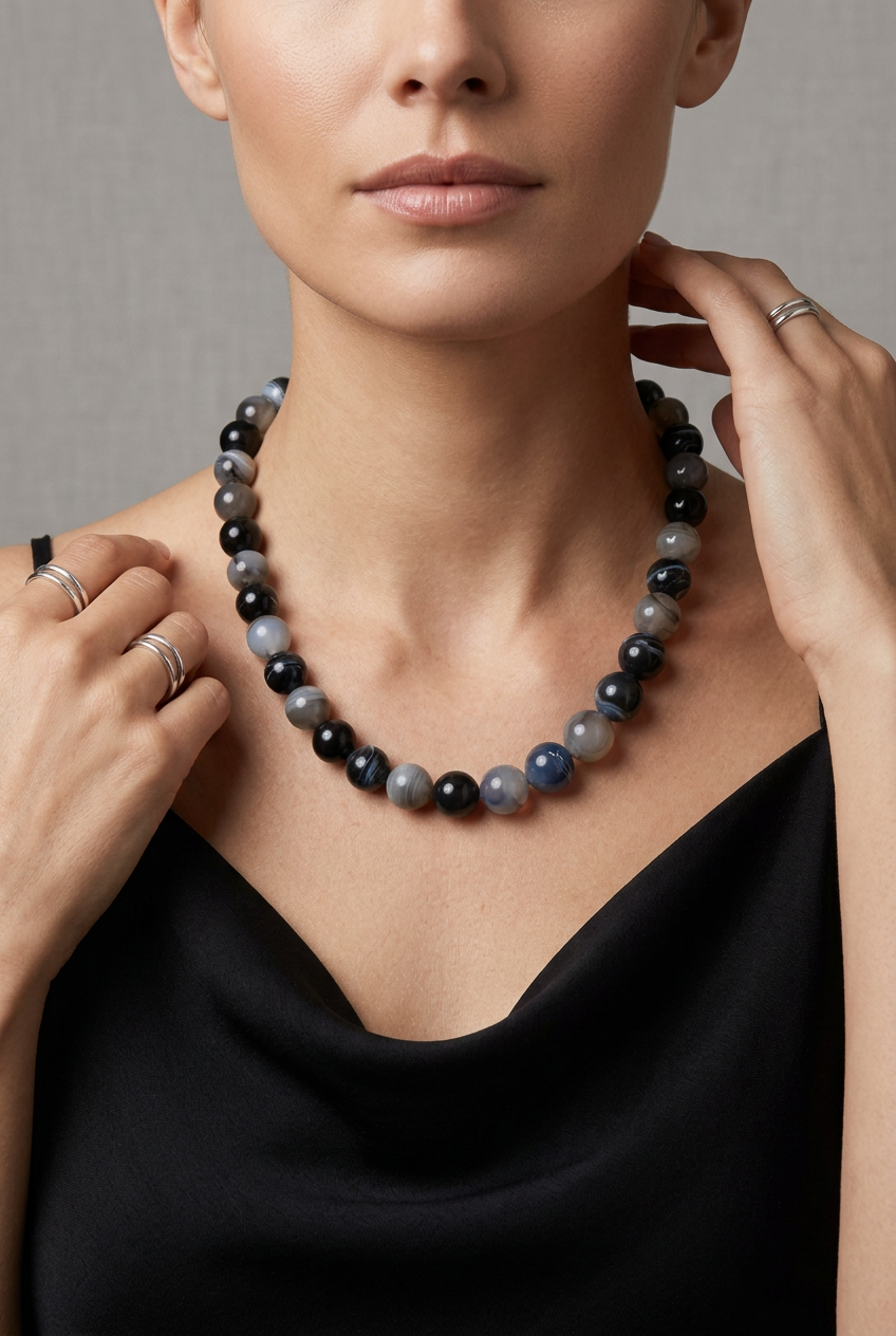 Mixed color beaded necklace with round, polished black, grey, and translucent white beads, 16-18 inches.