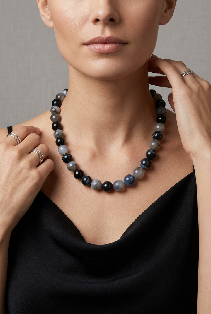 Mixed color beaded necklace with round, polished black, grey, and translucent white beads, 16-18 inches.