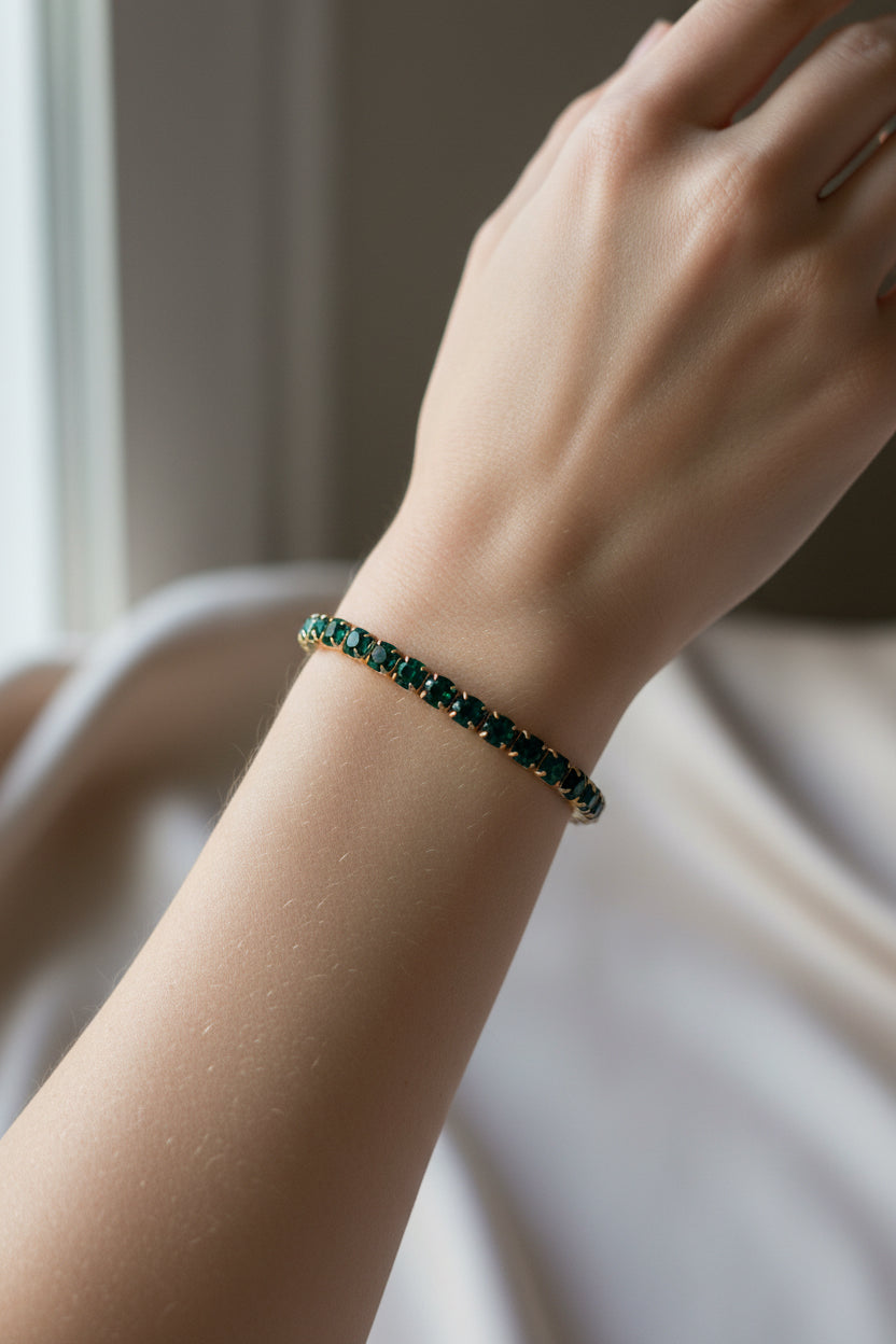 Water resistant stretch bracelet with evenly spaced green gemstone beads. Available in sizes S, M, and L.