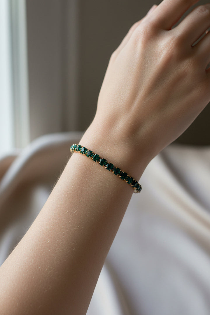Water resistant stretch bracelet with evenly spaced green gemstone beads. Available in sizes S, M, and L.