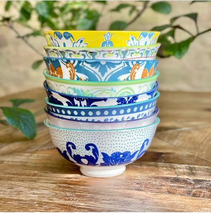 Six colorful, patterned Classic Collection Tidbit Bowls stacked. Available in small and medium sizes.