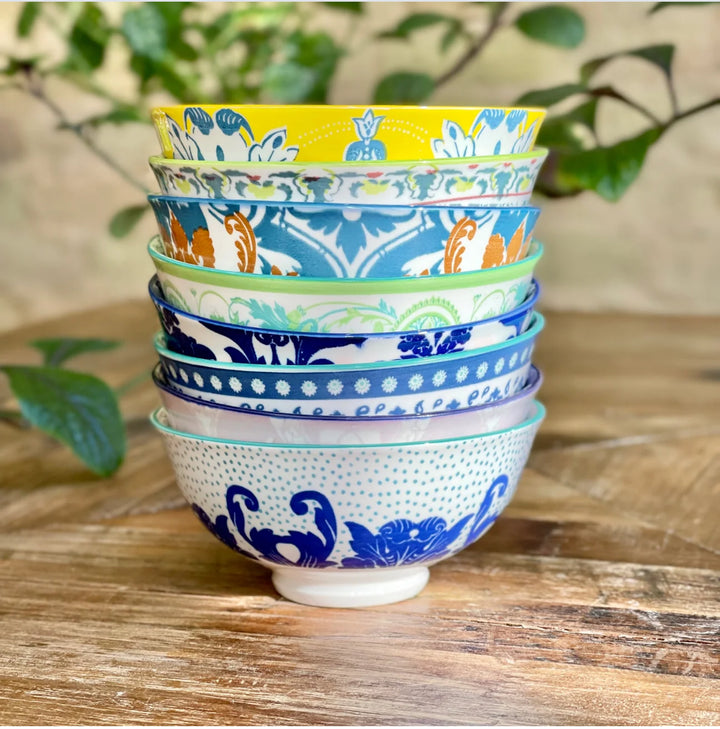 Six colorful, patterned Classic Collection Tidbit Bowls stacked. Available in small and medium sizes.
