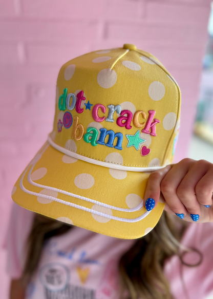 Yellow polka dot adjustable snapback hat with colorful “dot crack bam” embroidery. Available in one size fits most.