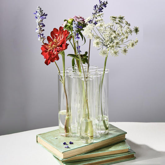 Set of 9 connected tube flower vases with blooms. Sizes: One size fit.