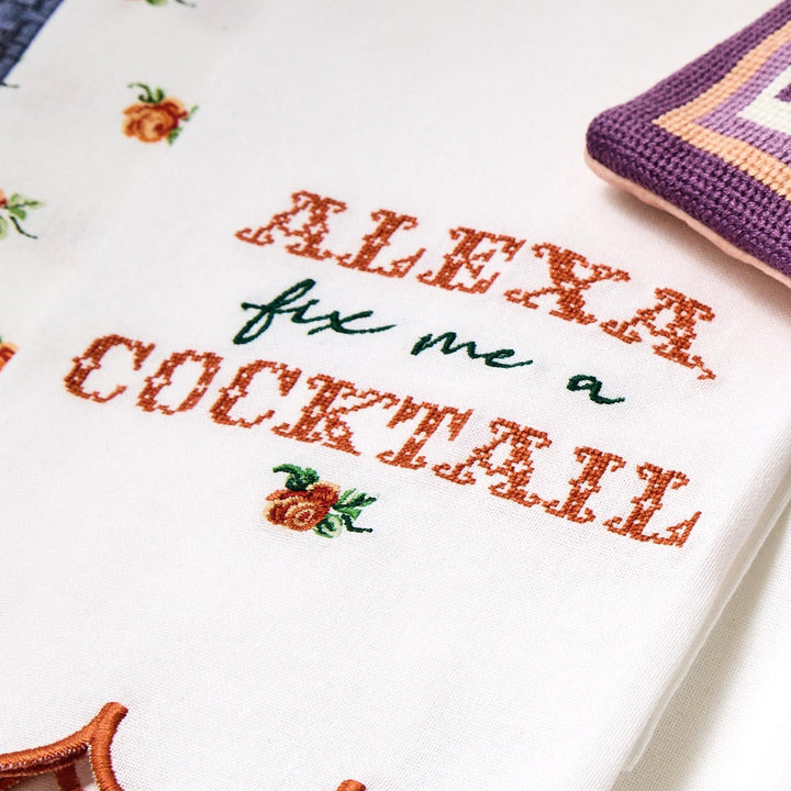 Alexa Kitchen Dish Towel: White cotton with "Alexa fix me a cocktail" embroidery in orange and green, floral patterns. Sizes available: 18"x28".