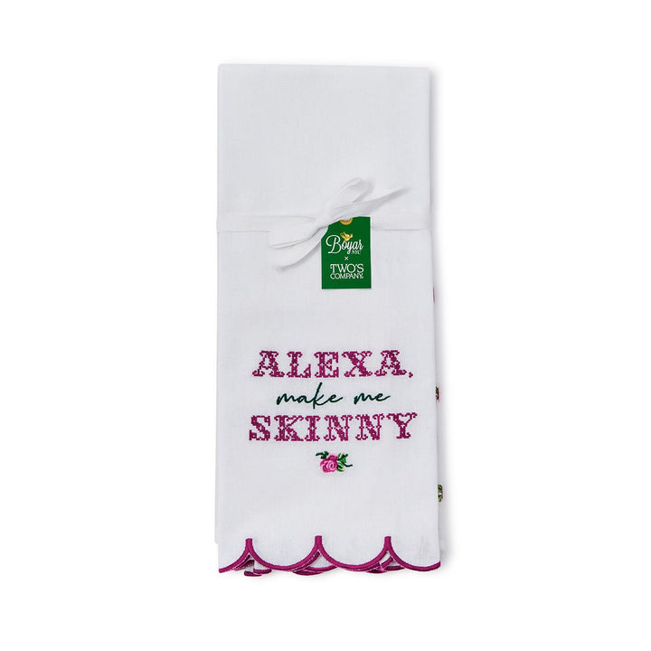 The Alexa Kitchen Dish Towel is crafted from soft white cotton with a scalloped purple border. It features "Alexa, make me skinny" embroidery and floral accents. Available size: standard kitchen towel size.