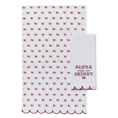 Set of two white cotton kitchen towels. One features a pink floral pattern. The second, the Alexa Kitchen Dish Towel, has scalloped edges and "ALEXA, make me SKINNY" embroidered in pink. Sizes: Standard kitchen towel dimensions.