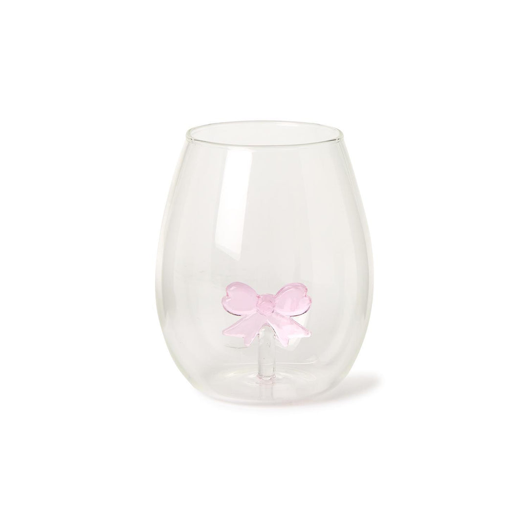 The Bow Stemless Wine Glass features a teardrop shape with a smooth surface and a unique double-walled design showcasing a pink bow. Sizes available: 12 oz.