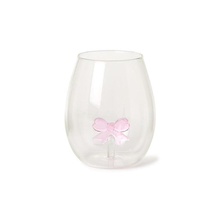 The Bow Stemless Wine Glass features a teardrop shape with a smooth surface and a unique double-walled design showcasing a pink bow. Sizes available: 12 oz.