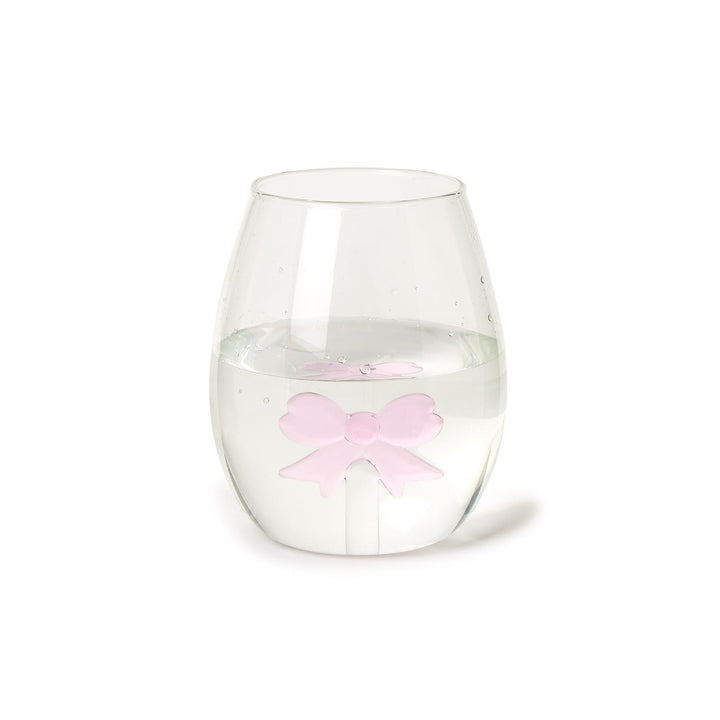 The Bow Stemless Wine Glass, highlighted by a pink bow-shaped ice cube, offers elegance and sophistication. Available sizes: 12 oz, 16 oz.
