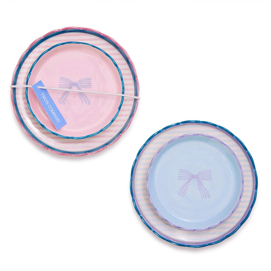Set of 2 scallop edge trinket dishes with bow design. Includes large and small plates in pink and light blue.
