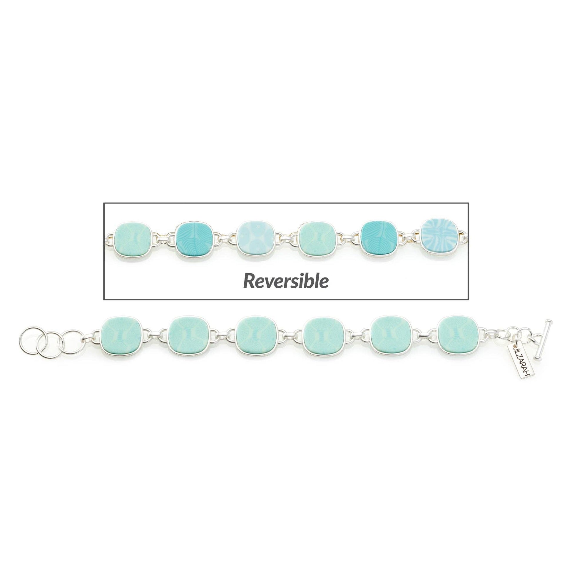 The Palm Beach Reversible Coin Bracelet features light blue, square-shaped links with ocean wave and starfish motifs. Matte gold plating, silver chain connection, clasps at both ends. Available sizes: 6.5", 7", 7.5".