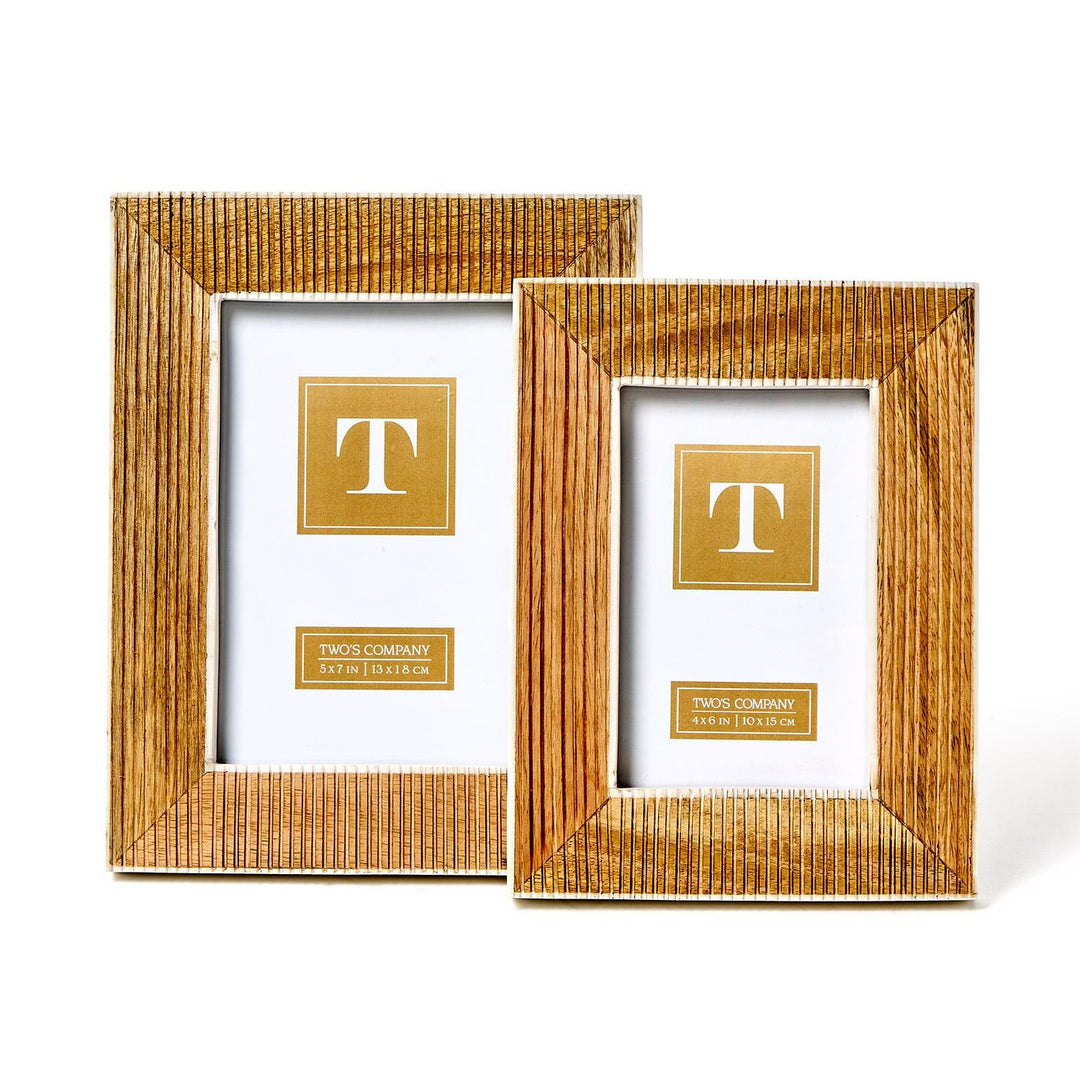 Two striated textured frames made of mango wood. Sizes: larger frame on left, smaller on right. Each includes a golden placeholder with a "T" in the center.