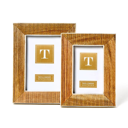 Two striated textured frames made of mango wood. Sizes: larger frame on left, smaller on right. Each includes a golden placeholder with a "T" in the center.