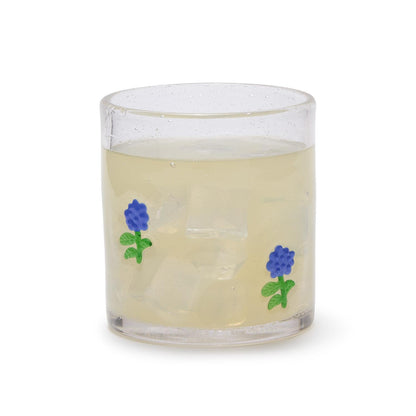 Hydrangea Clear Bubble Double Old Fashion Glass, 12 oz, with two small blue flower designs, filled with a light drink and ice.