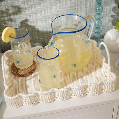 White all-weather wicker scalloped tray with handles, blue rims, and fish designs. Available in 16" and 20" sizes.