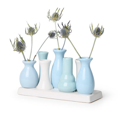 The Blue Hues Multi Vase with 7 Sections on a Platform features blue and white porcelain vases on a rectangular tray. Sizes available: One size platform with 7 sections.