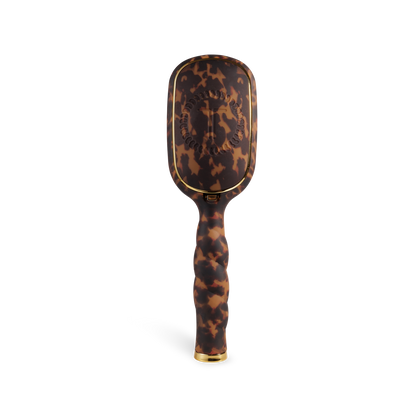 The Boar Bristle Hair Brush | Tortoise has a brown tortoiseshell pattern, gold accents, ergonomic handle; available in two sizes.