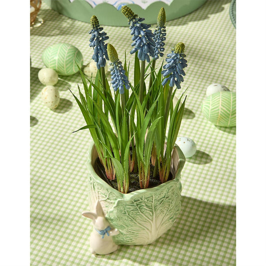 Lifelike blue grape hyacinth in a green leaf-patterned pot. Available in small, medium, and large sizes.